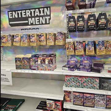 A store's "ENTERTAINMENT" section display features Pokémon and One Piece trading card products, including Ascended Heroes tins and One Piece booster packs, matching the collectible TCG haul described in the post.