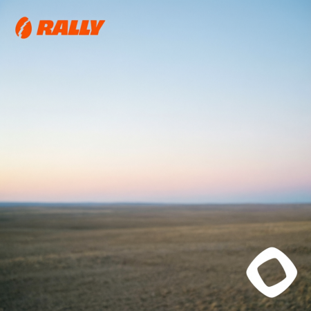 Blurred landscape photograph of a flat desert terrain under a gradient pink and blue sky, featuring an orange 'RALLY' logo in the top left corner and a white app icon in the bottom right.