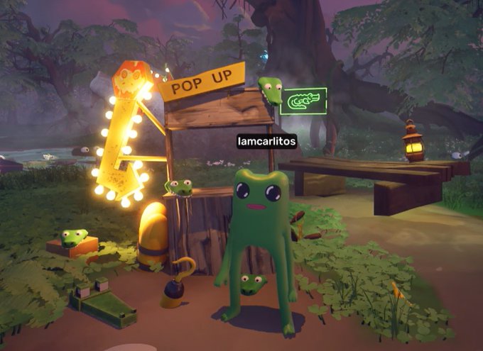 A green frog character stands in a vibrant video game environment featuring a 'POP UP' sign with lights, small frog companions, and a wooden bench with a lantern in a forest setting.