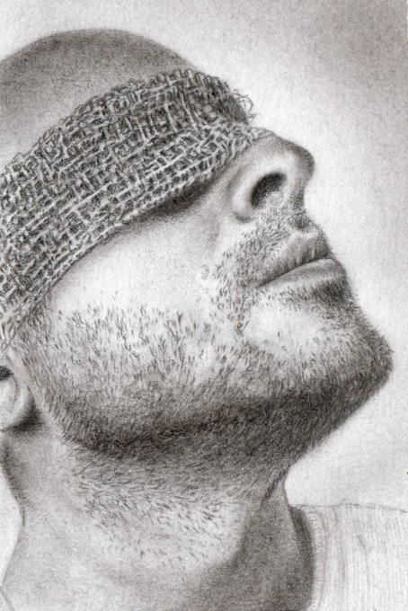 Detailed pencil drawing/portrait of a man with a beard wearing a textured knit beanie, drawn from a side angle looking upward, rendered in grayscale with fine shading detail.