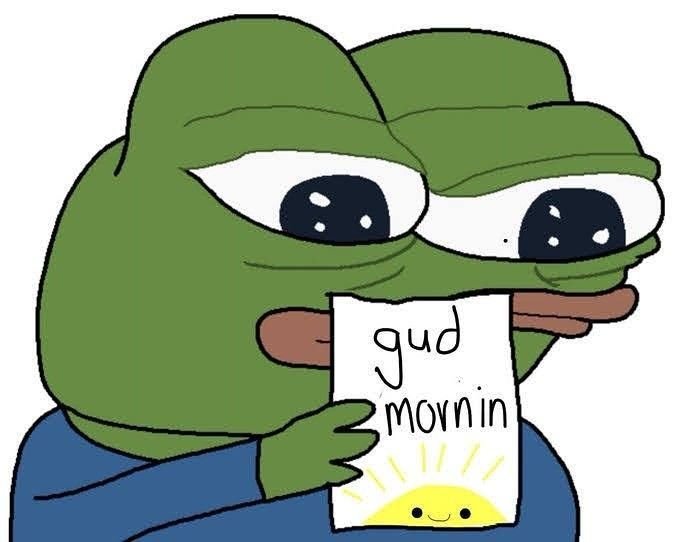 A cartoon frog character holding a note that says 'gud mornin' with a small smiling sun drawn below the text.