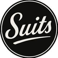 A simple circular black logo featuring the word "Suits" written in white cursive text.