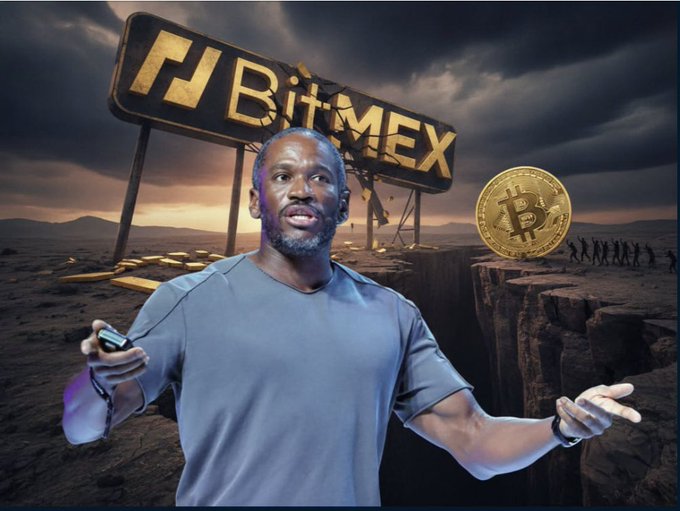 A man in a blue shirt stands in a desert landscape with a large golden BitMEX sign behind him and a floating Bitcoin coin, while silhouettes of people approach in the distance.