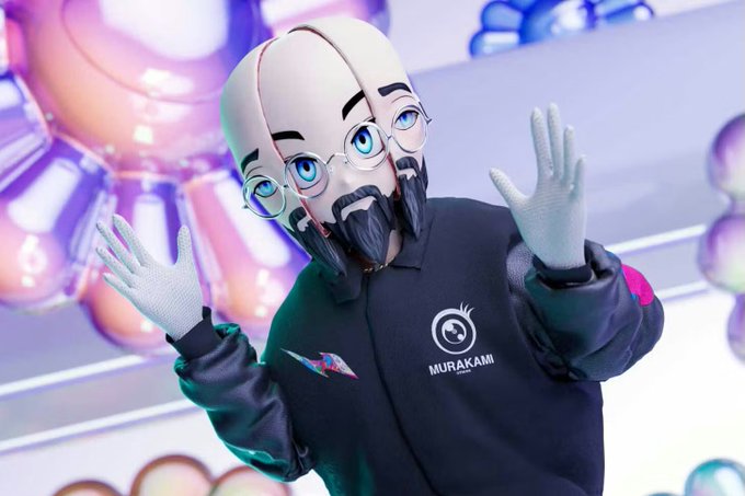 Photo of a person wearing a Murakami-branded mascot head and jacket at an event, set against a colorful background of pastel balloons.