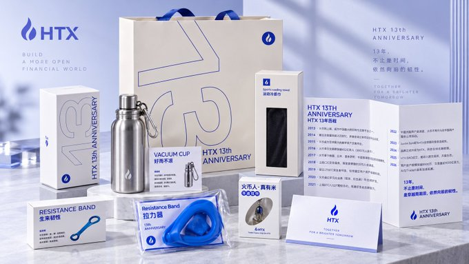 A promotional image showcasing HTX's 13th Anniversary merchandise, featuring branded items including a stainless steel vacuum cup, resistance band, and commemorative card highlighting key milestones from 2013 to 2021. The displayed timeline details the exchange's evolution from its 2013 launch through years of growth, regulatory developments, and its 2023 rebranding from Huobi to HTX.