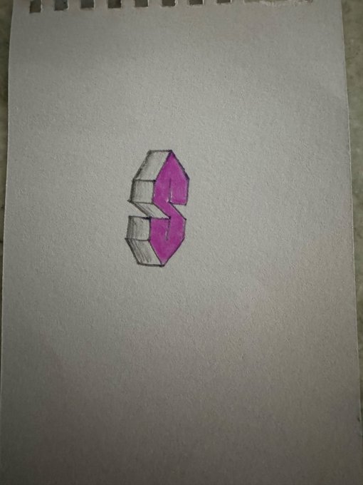 A hand-drawn geometric magenta and gray emblem appears on a sheet of white sketch paper.