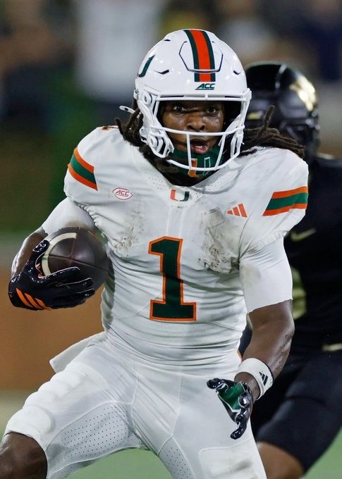 A Miami Hurricanes football player wearing jersey #1 in white with green and orange accents runs with the football, with the ACC logo visible on the jersey.