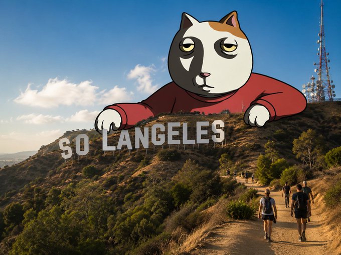 A digitally edited image features a giant cartoon cat wearing a red shirt superimposed behind the iconic "Hollywood" sign, with the text changed to read "SO LANGELES," as hikers walk along a trail below the hills. The whimsical edit plays on the post's greeting "good morning solangeleees" by combining "SoCal" with "Los Angeles" into the cat-themed pun on the sign.