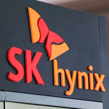 The image shows the red and orange "SK hynix" logo on a dark wall. The accompanying post references tickers like $THETA, $TFUEL, and $TDROP, but the logo does not relate to those, as SK Hynix (ticker HXSCY) is a South Korean semiconductor and memory chip manufacturer.