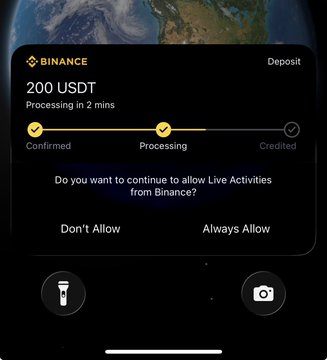An iPhone screen displays a Binance notification confirming a 200 USDT deposit is "Processing in 2 mins," accompanied by a prompt to "Always Allow" Live Activities from Binance. The image appears to be used in a giveaway scam, with the accompanying text falsely promising to send 200 USDT to followers who share their $SOL wallet, though Binance deals in crypto assets rather than solana-based giveaways.