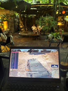 A laptop displays a PUBG gameplay match in what appears to be a café setting, humorously illustrating the post's joke about lower-tier crypto KOLs spending their weekends gaming instead of networking and securing high-value partnerships.