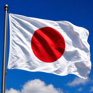 The image features a Japanese flag flying high against a blue sky with white clouds. The flag has a red circle at its center, which represents the country of Japan. The text "Japan' three largest banks are planning to launch stablecoins" is written below the flag, indicating that there might be discussions or plans about launching stablecoins in Japan's banking system.