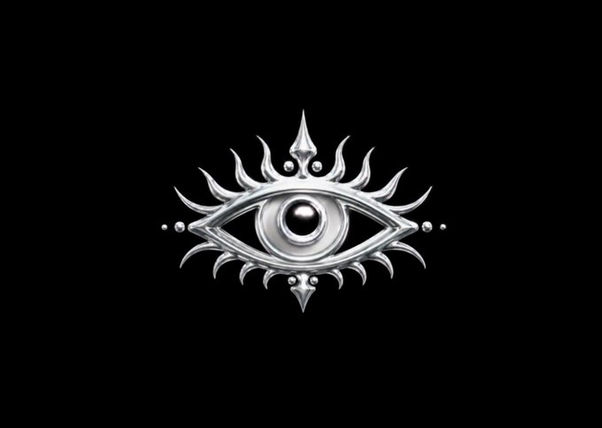 A silver metallic emblem featuring an open eye with rays/spikes radiating outward, centered on a black background.