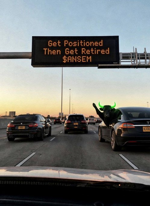A highway scene at sunset showing a highway sign that reads 'Get Positioned Then Get Retired $ANSEM', with a green bull-headed figure waving from a car window.