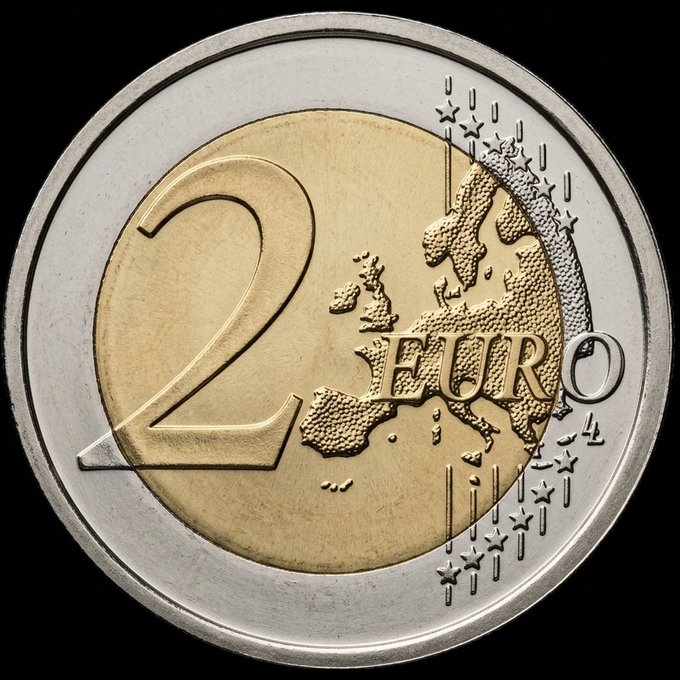The image features a round coin with the word "2" written on it in gold letters. The coin has an illustration of Europe, which is part of the European Union (EU), on its surface. The background of the image is black, making the gold and silver color scheme of the coin stand out prominently. The text accompanying the coin reads: "Just upload the new sheet on the checker! We spent all the morning to type again the sheet, with the not unread EVM from OpenSea Now finger crossed!".
