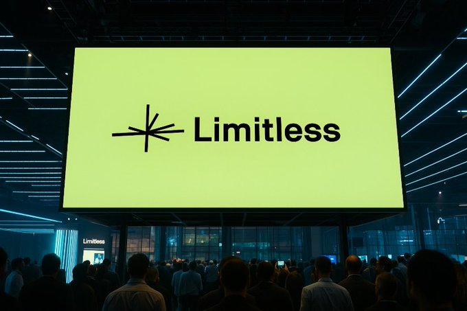 A large illuminated display screen showing the 'Limitless' logo with a starburst symbol in a modern venue with blue linear lighting, with a crowd of people gathered in the foreground.