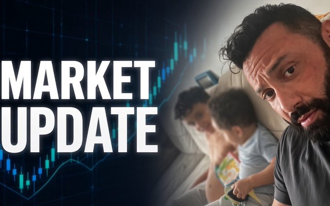 The image shows a close-up of a man with a surprised expression, sitting next to a woman and child on a couch, overlaid with the text "MARKET UPDATE" and a candlestick chart background.

The thumbnail promotes the creator's Weekend Market Update video, featuring his family alongside the bold "MARKET UPDATE" title and trading chart graphics.