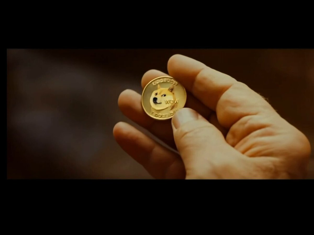 The image features a hand holding up a gold coin with a black "Ethereum" logo on it. The caption below the coin reads "Who controls the memes, controls the Universe - Elon Musk". This suggests that the coin might be related to Bitcoin or Ethereum, which are digital currencies controlled by individuals like Elon Musk.