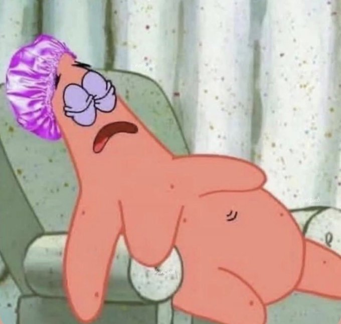 An image of Patrick Star from SpongeBob SquarePants wearing a purple shower cap and a purple flower hair accessory, looking exhausted with half-closed eyes.