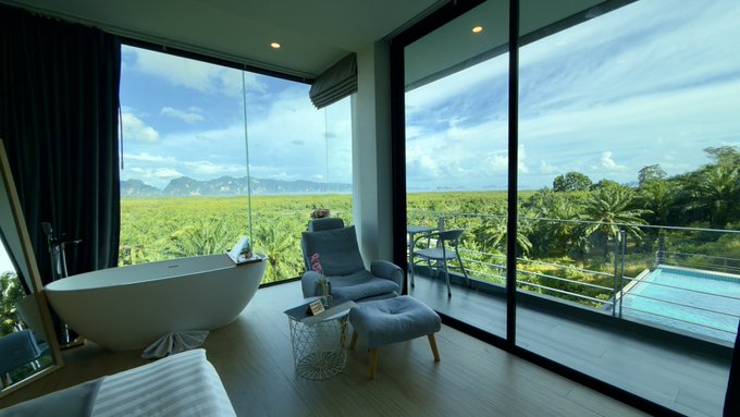 A luxurious bathroom with a soaking tub, recliner, and a private pool overlooks a lush green landscape and ocean vista. The post references "13 days left," implying a countdown until "Mommy" returns, with a wish for a "bull market" to celebrate.