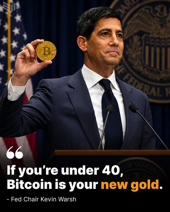 In the image, a man dressed in a suit stands behind a podium at a government building, holding up a gold coin as if presenting it for a speech or press conference. The text "If you're under 40, Bitcoin is your new gold" is displayed above him, suggesting that he might be discussing the value of Bitcoin and its potential impact on the economy.