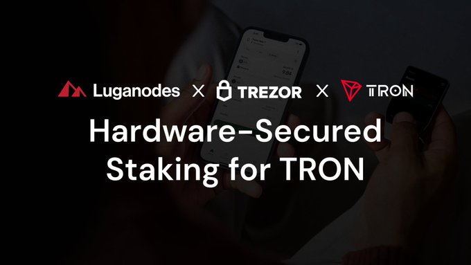 Promotional graphic for a collaboration between Luganodes, Trezor, and Tron featuring the text 'Hardware-Secured Staking for TRON' over a darkened background of hands holding phones.