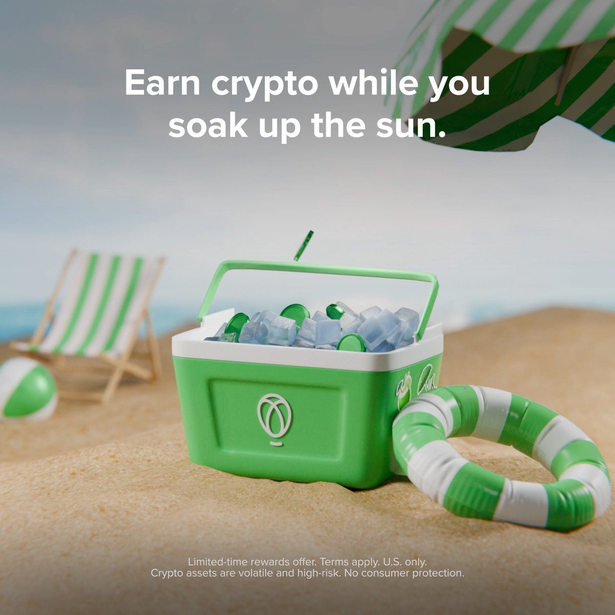 A green and white branded cooler sits on a sandy beach beside a striped beach chair and umbrella, featuring the tagline "Earn crypto while you soak up the sun" with the Robinhood logo and a green-and-white striped life preserver—visually reinforcing the post's message of "growing your portfolio while you soak up the sun" through Robinhood's Auto-Invest and XRP rewards program.