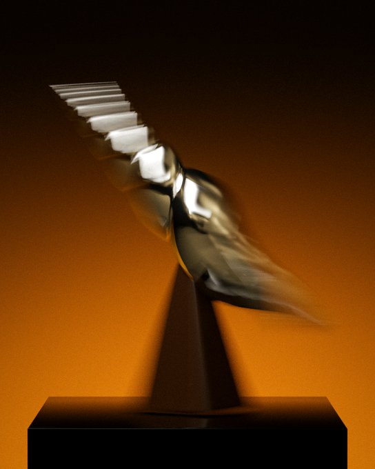 An abstract sculpture with a spiral of silver elements rests on a dark pyramidal base against an orange gradient background.