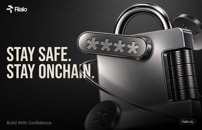 An advertisement for Rialo featuring a large metal padlock with a password combination dial, with the text 'STAY SAFE. STAY ONCHAIN.' and the website rialo.io.