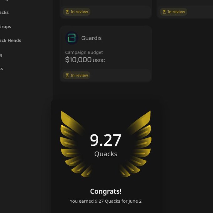 The image shows a black screen with a gold design of wings on it, giving the impression that someone has been awarded or recognized with a gold award featuring two wings, possibly representing 9.27 Quacks. The context seems to be related to the Wallchain app and its campaign budget management feature. It says "Congratulations! You earned 9.27 Quacks for June 2." on the screen.