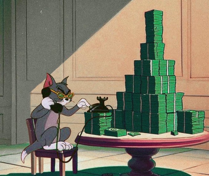 An animated gray cat wearing a red hat and green goggles sits at a table counting stacks of cash bound with "20" labels while holding an old-fashioned telephone receiver. The towering piles of money and the cat's refusal to engage with the phone humorously illustrate the meme's warning to new crypto investors not to answer calls from ex-girlfriends during a bull market when they're finally making money.