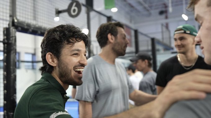 The image shows a group of men standing together, with one man wearing a green shirt and another wearing a gray shirt. They are all smiling at each other, suggesting they are having a good time. The background reveals that this gathering takes place inside a building, possibly an indoor sports facility or a similar setting. A sign is visible in the room, which reads "6". One of the men has his arm around another man's shoulder, indicating a friendly interaction among the group members.

The post by Michael Saylor about Bitcoin adds context to the image and emphasizes the importance of digital currency in today's world. The image captures a moment where these friends are enjoying their time together while discussing the significance of Bitcoin and its impact on society.