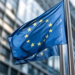 The European Union flag waves in the wind, symbolizing the regulatory debate as Nasdaq and 27 other firms push back against the EU's proposed €100 billion cap on tokenized securities, arguing it could hinder the growth of European tokenization.