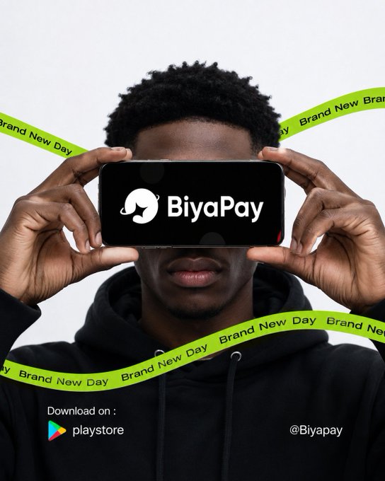 A promotional graphic for BiyaPay featuring a person holding a phone displaying the app's logo, with "Brand New Day" ribbon text and a Play Store download link.