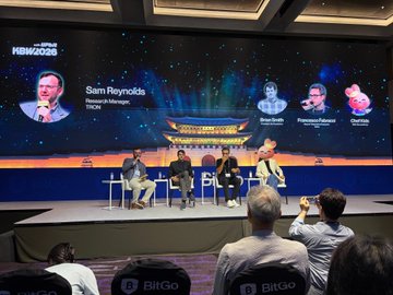 A panel discussion at the HCM2025 summit with speakers on stage including Sam Reynolds, Senior Manager at TRON, moderated by Brian Santos and moderated by Roman Davies, with the event sponsored by BitGo.