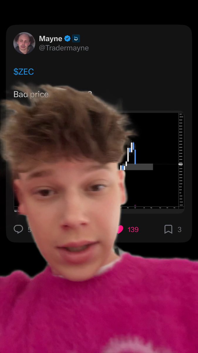 The image shows a young boy with short brown hair wearing a pink sweater, looking at his phone screen which displays a message from someone named "MAYNO". The text of the message reads "$ZEC dumps 75% overnight", indicating that the person who sent the message is upset about something happening on their account. 

The image also contains a screenshot of a graph with a price line, suggesting that the boy might be interested in tracking stock prices or analyzing market trends.