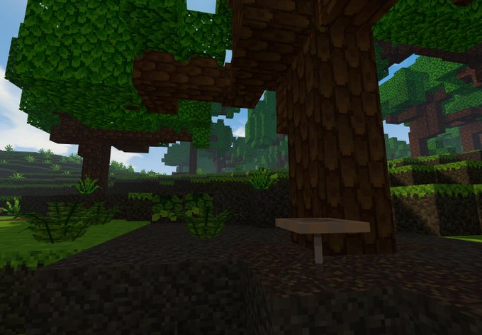 Minecraft screenshot of a forest scene with oak trees, grass, leaves, and a brown mushroom on the ground.
