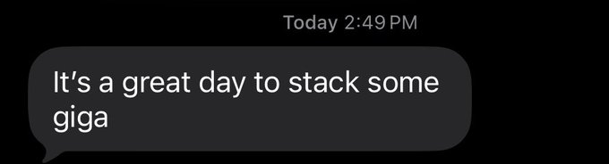 A dark iMessage text bubble with white text reading 'It's a great day to stack some giga', sent at 2:49 PM.