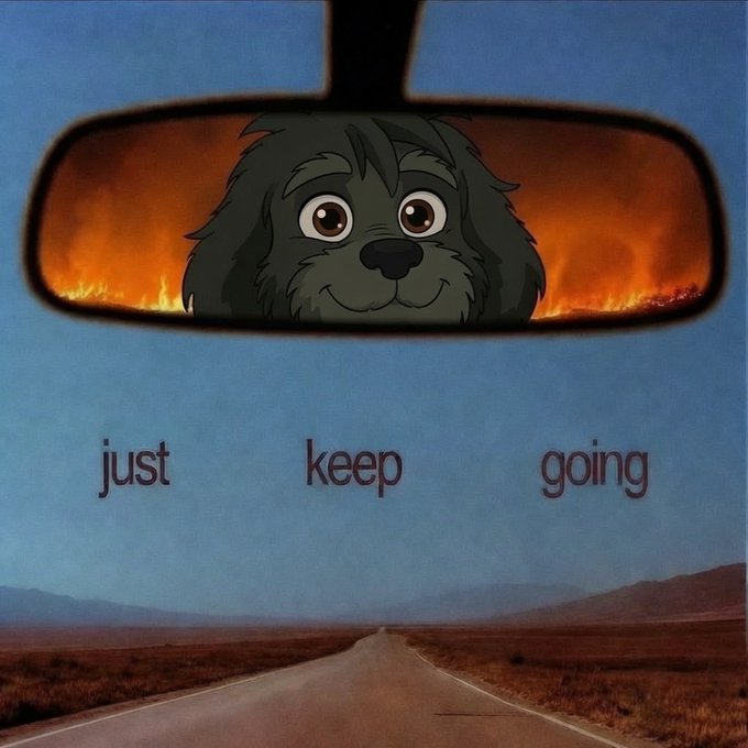 A cartoon shaggy black dog with a calm smile appears in a rearview mirror reflecting fiery flames, set above an open desert highway with the words "just keep going." The image humorously contrasts a peaceful canine mascot with the chaos of unsaid tasks, echoing the post's warning that the "jobs not finished" are still burning hot behind us.