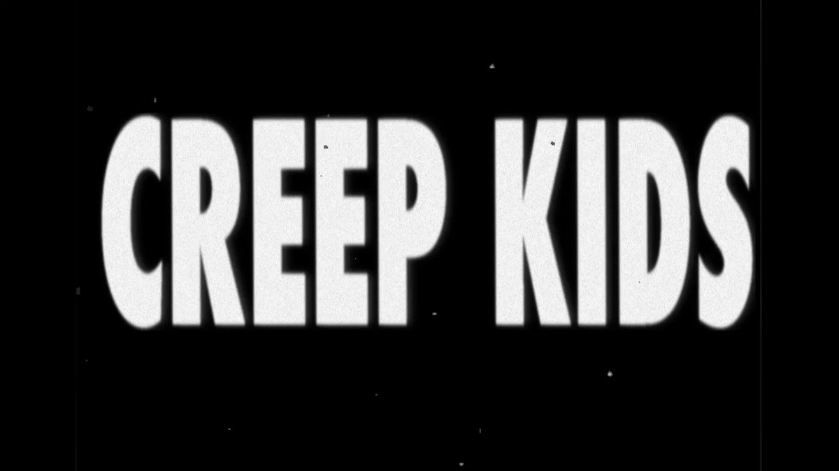 The image features a black background with white text that reads "Creep Kids". The text appears to be floating or shimmering, giving it an ethereal quality. The caption below the image provides additional information about the content of the image.