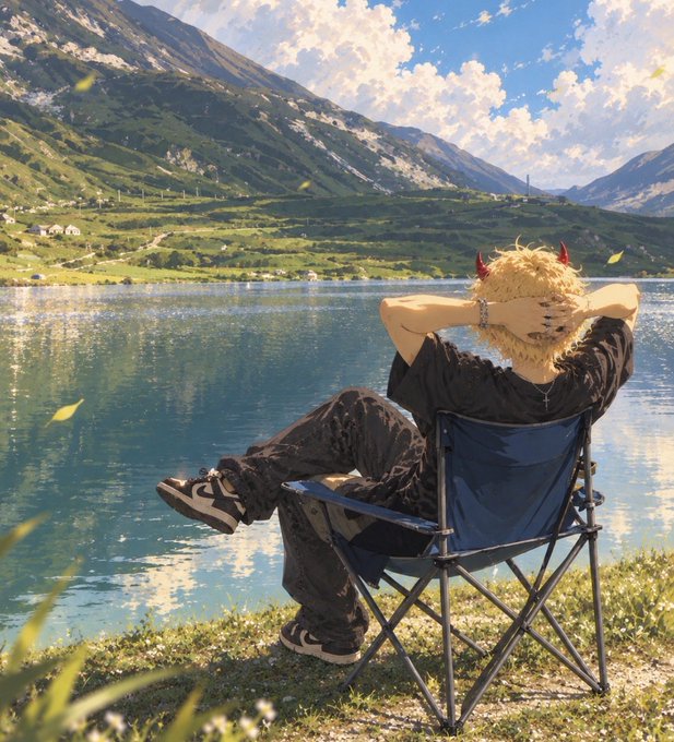 An anime-style character with blonde hair and red horns sits in a blue folding chair facing a scenic mountain lake under a partly cloudy sky.
