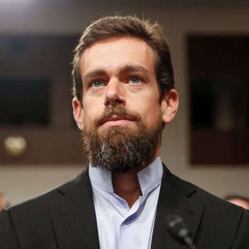 Jack Dorsey, CEO of Twitter and Square, sits in formal attire with a serious expression, illustrating the accompanying quote about his belief in Bitcoin becoming the internet's native currency.