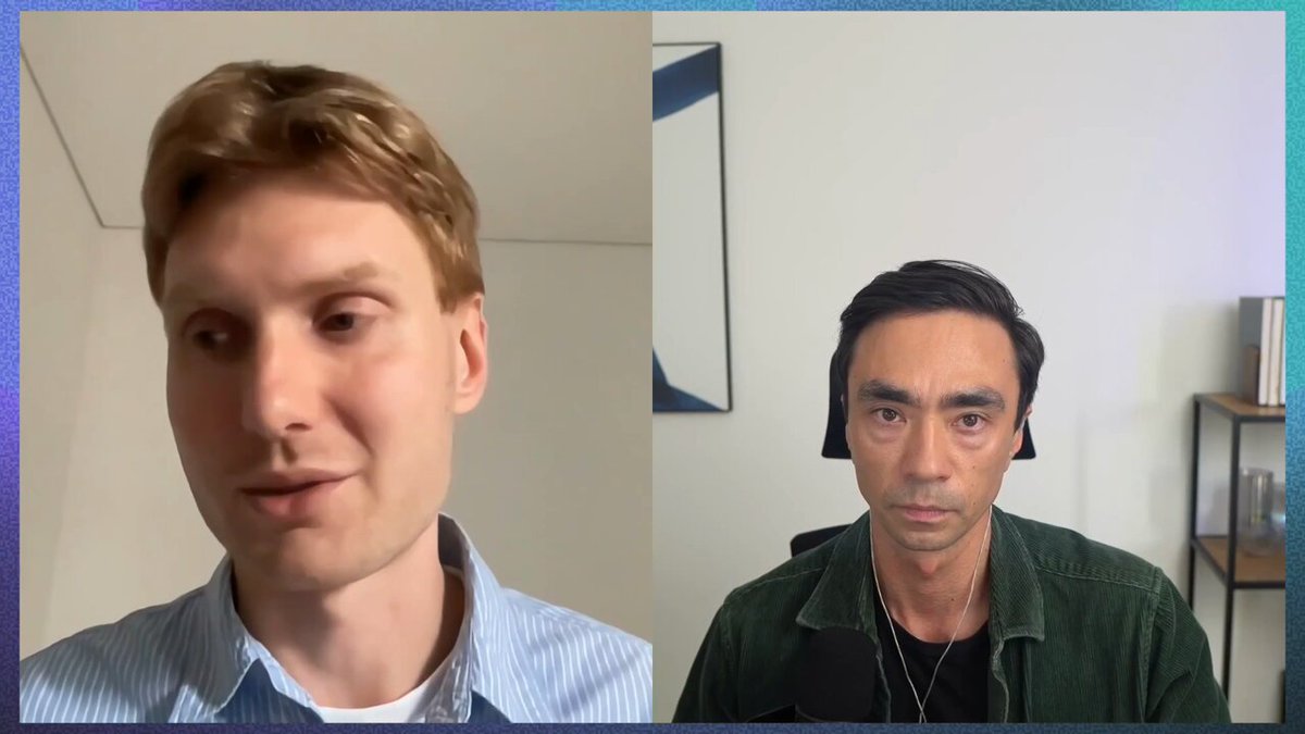 The image shows two men sitting next to each other at a desk with their faces displayed on a computer screen. The man on the left has short hair, while the man on the right has long hair. They appear to be engaged in an interview or discussion about cryptocurrency and its future.