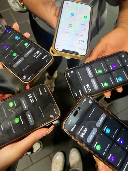 A circle of hands holds up smartphones displaying crypto portfolio apps with negative P/L figures like -$8.23, -$5.27, -$0.27, -$0.00, and -$4.00, symbolizing friends quitting trading together amid losses. The image visually captures the "brotherhood" of crypto traders shown the door by their losing positions, reinforcing the caption's farewell to the "coins game."
