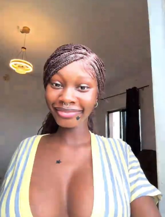 A young woman with braided hair, a nose ring, and a striped top smiles at the camera in a well-lit room with a decorative ceiling light. The caption alongside the image humorously challenges a flirty or absurd message, suggesting skepticism toward exaggerated romantic claims in a playful Nigerian Pidgin English tone.