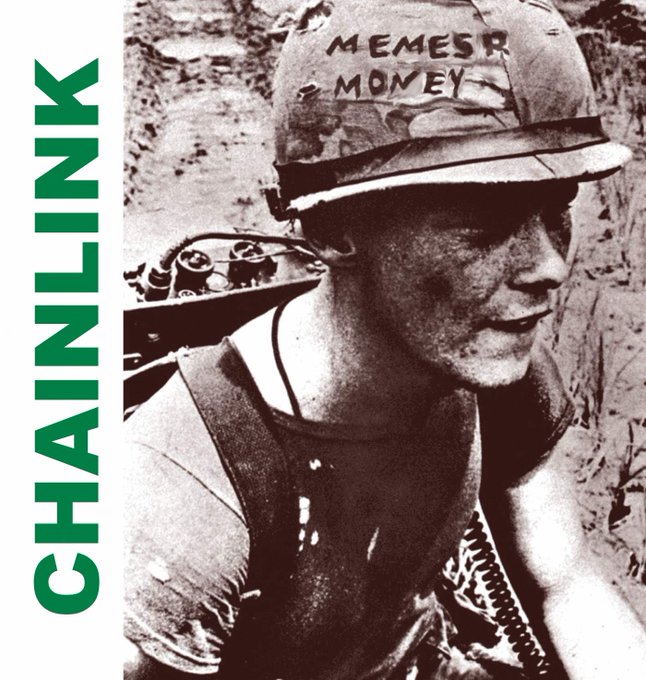 A black-and-white photo of a soldier wearing a helmet with 'MEMES R MONEY' written on it in marker, with the green 'CHAINLINK' logo prominently displayed along the left side.
