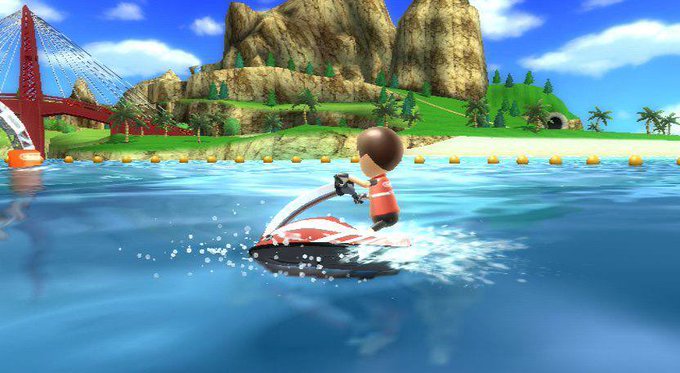 A 3D animated video game scene showing a character in an orange vest riding a red and white jet ski on blue water, with a red suspension bridge, green islands, and mountains in the background.