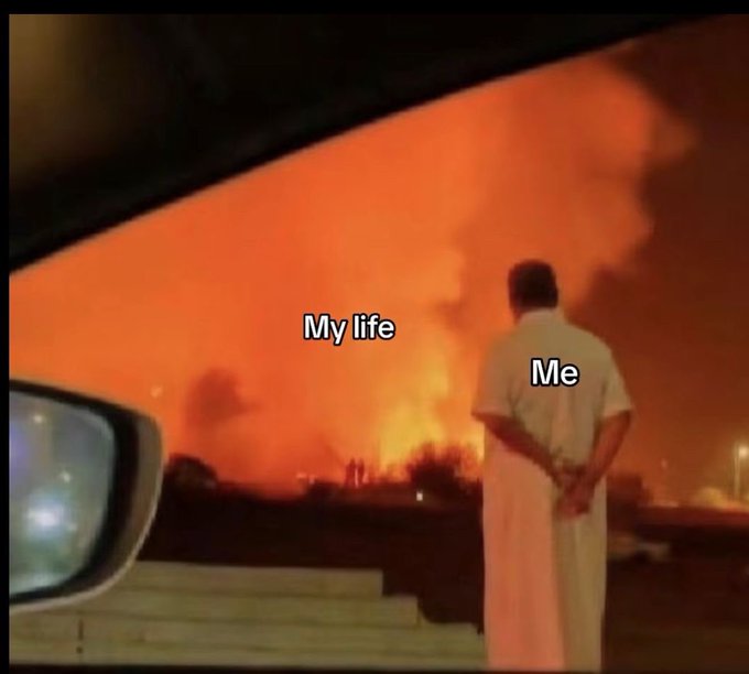 The image is a meme showing a man calmly watching a massive fire, with the text "My life" labeling the flames and "Me" labeling the man. It humorously relates to the post's wish for a "rực rỡ" (brilliant/glowing) weekend, playfully depicting the poster embracing life's fiery chaos with cool composure.