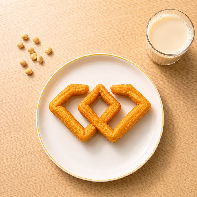 The image features a white plate with three golden-brown pastries arranged in a triangle formation, possibly waffles or crepes. The plate is placed on a wooden table next to a glass of milk. The background consists of several small beans scattered around the plate and the table.