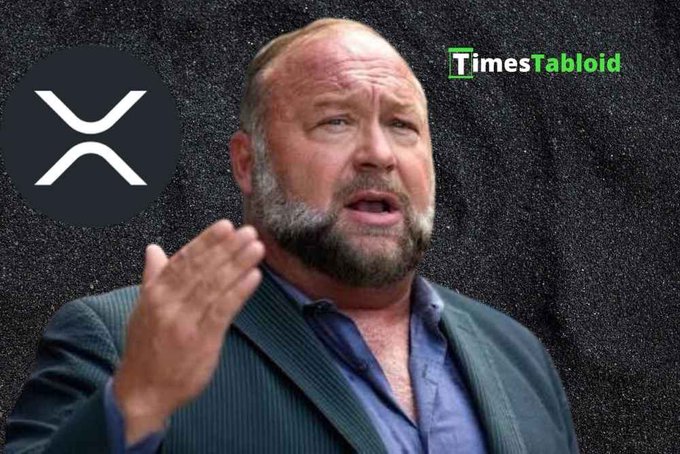 A man with a beard wearing a dark blazer and blue shirt gesturing while speaking, with an XRP cryptocurrency logo overlay and 'TimesTabloid' watermark.